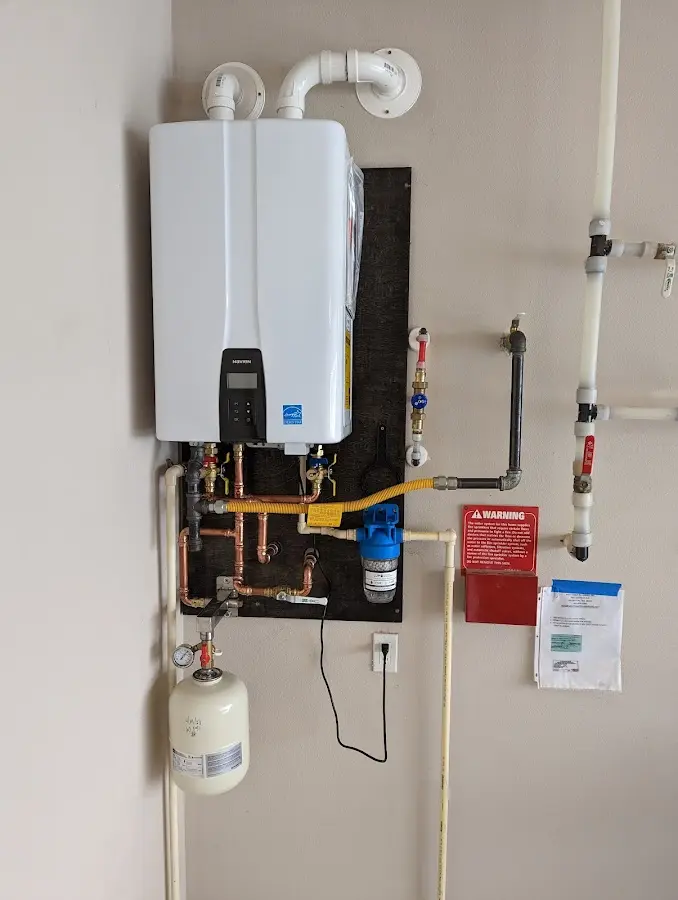 Professional plumber installing copper piping in a Danbury home